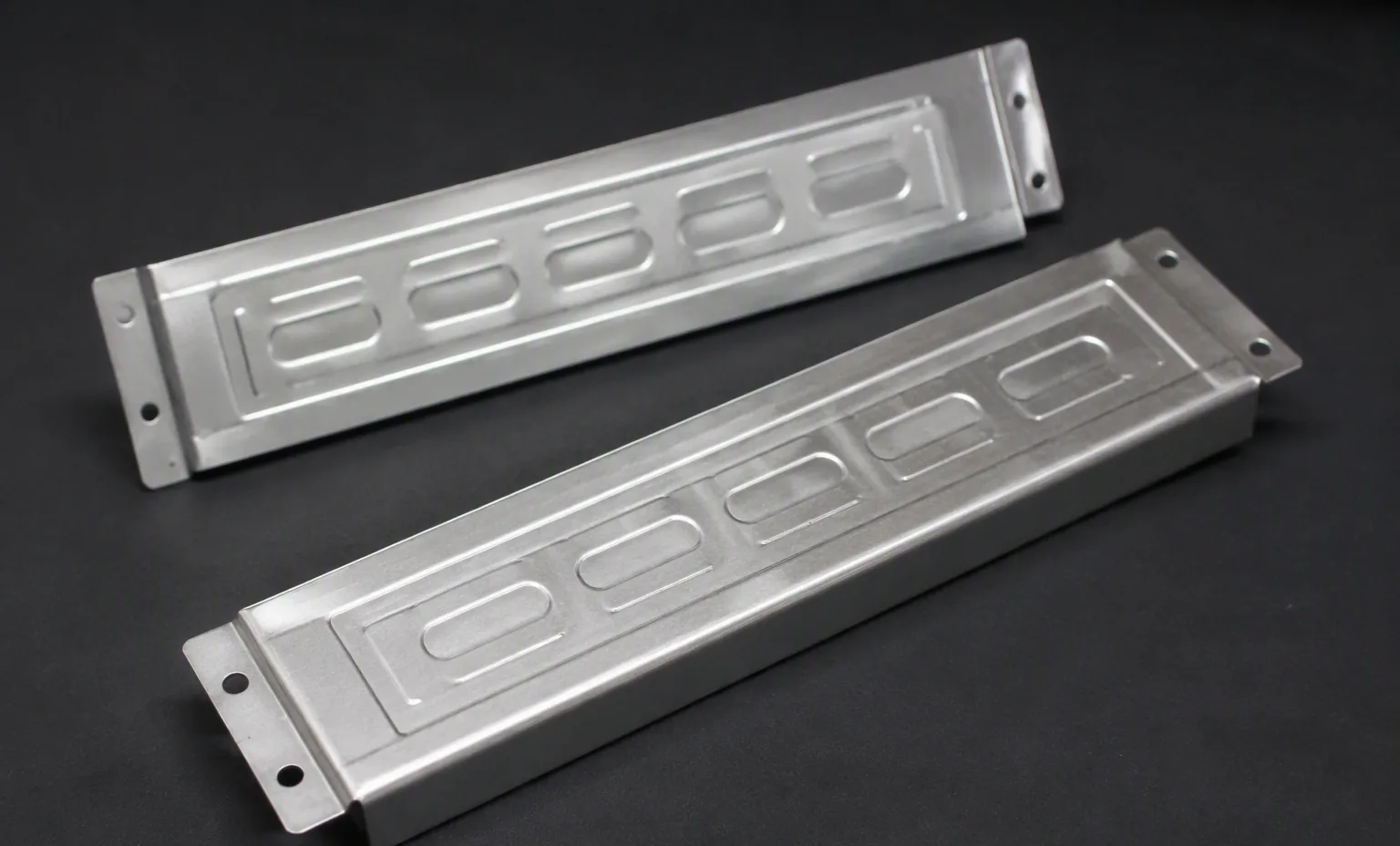 metal drive bay blank filler plates for a 3.5 inch server bay, dark studio.