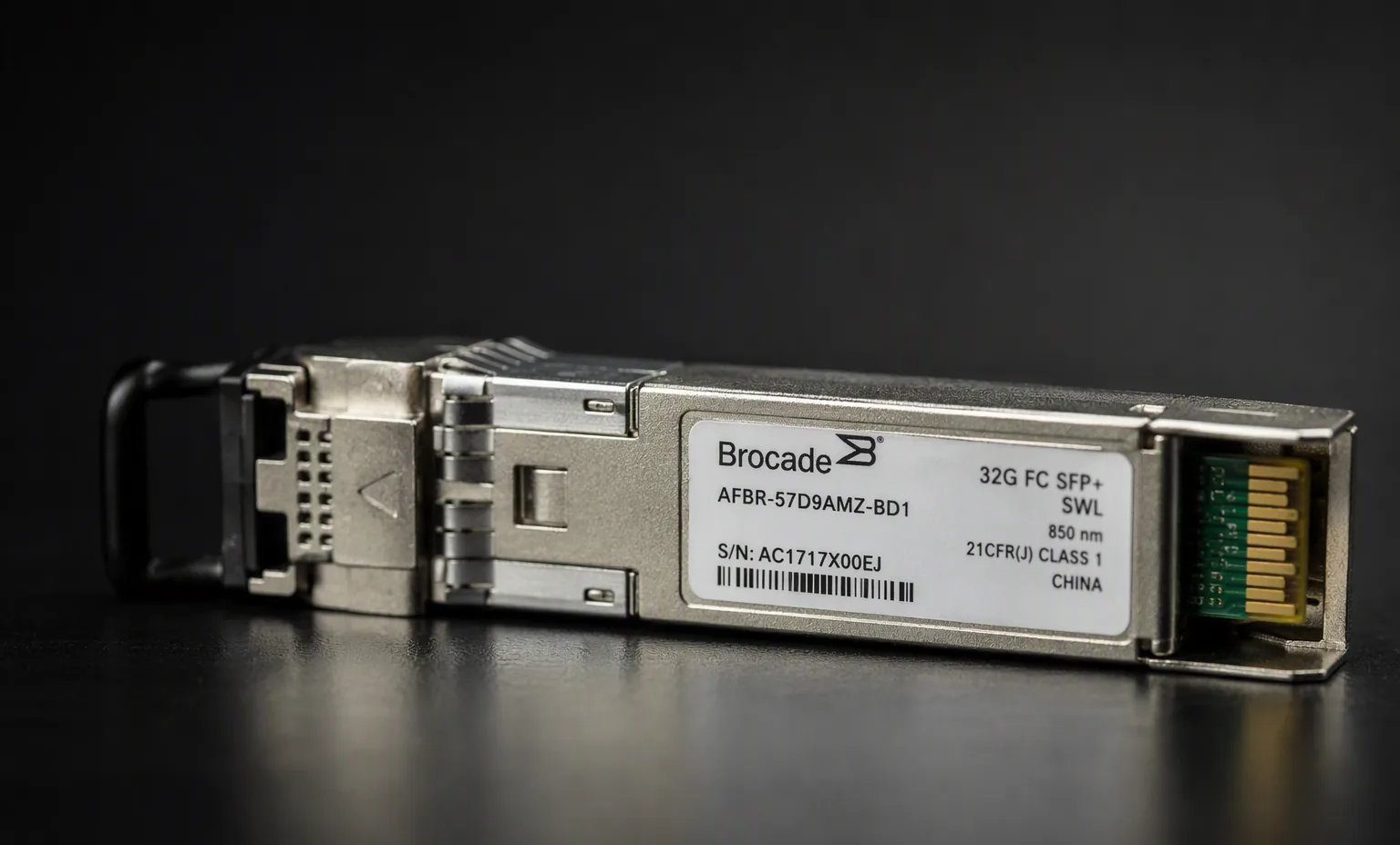Brocade-branded 32G FC SFP+ optical transceiver module, dark studio macro.