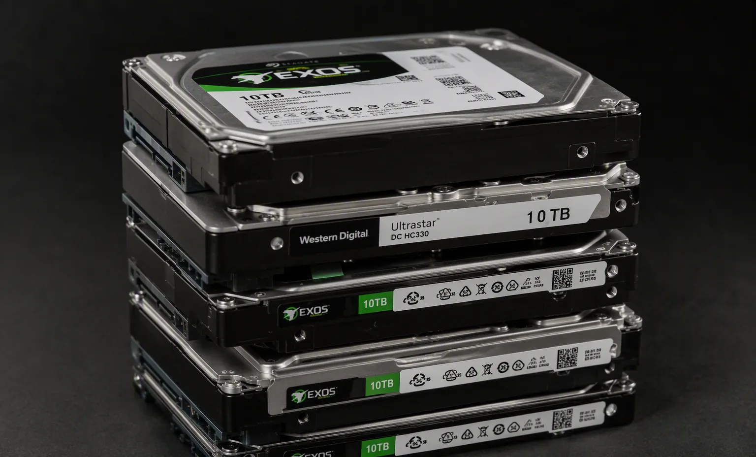 Photorealistic photograph of a neat stack of five real enterprise 3.5 inch hard drives Seagate Exos and WD Ultrastar, dark studio still life.