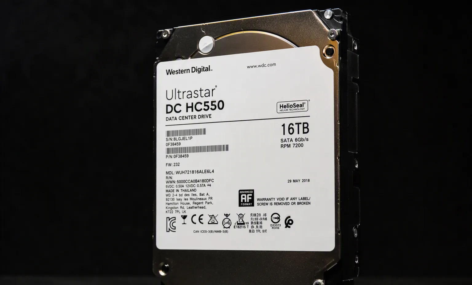 WD Ultrastar DC HC550 16TB helium enterprise hard drive, three-quarter view, dark product photography.